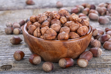 domestic hazelnuts in a wooden bowl on old rustic table