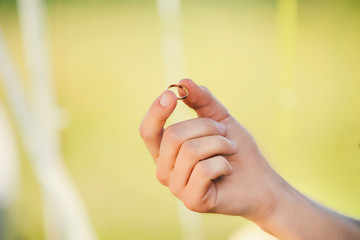 hand with gold ring on wedding ceremony