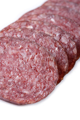 Sliced smoked sausage macro isolated on white. Vertical