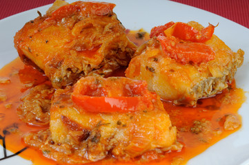 Fish dish with onions and peppers sauce