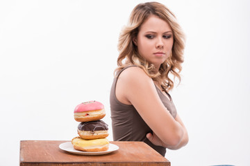 Young attractive woman with doughnuts isolated on white backgrou