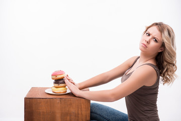 Young attractive woman with doughnuts isolated on white backgrou