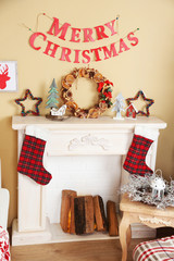 Beautiful Christmas interior with sofa, decorative fireplace