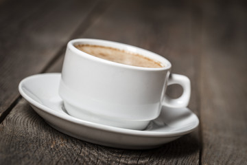 White coffee cup on wooden table