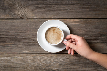 Woman holding warm mug with fresh coffee