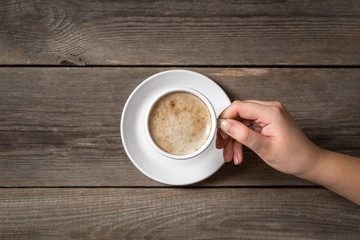 Woman holding cup of coffee. 