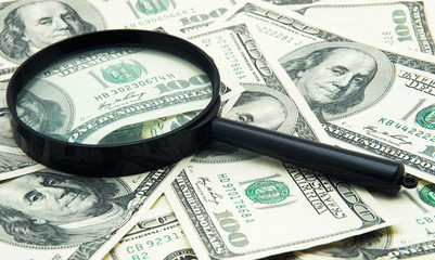 Magnifying glass and money 