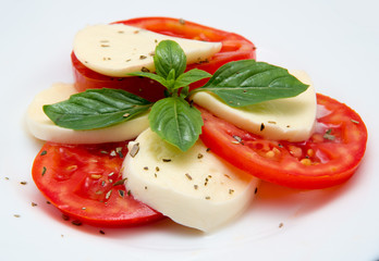 Caprese salad with mozarella cheese, tomatoes and basil