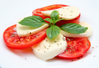 Caprese salad with mozarella cheese, tomatoes and basil