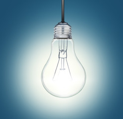 A light bulb shines in the darkness bright light