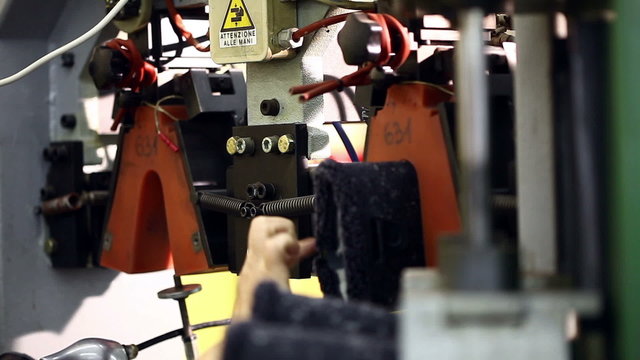 View of worker fixes boots in machine