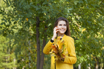 Happy beautiful woman calling by phone