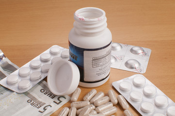 medicine on table with EURO money