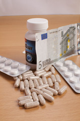 medicine on table with EURO money
