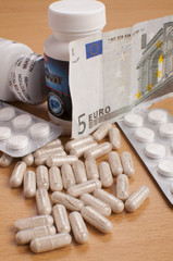 medicine on table with EURO money