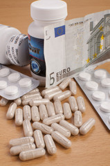 medicine on table with EURO money