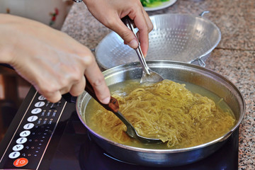 Chef boil the egg noodle with in infrared stove