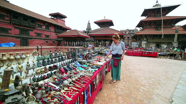 Female tourist choosing souvenir