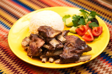 the rack of lamb with rice and sauce on the yellow plate