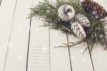 Spruce branches  and vintage decorations on  wooden background.