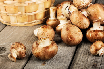 Raw fresh mushrooms with a basket