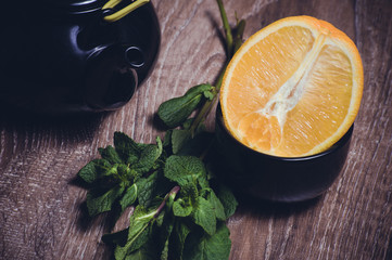 orange and mint tea served in cup