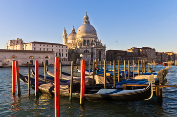 Fototapeta na wymiar Morning in Venice, gondolas, Grand Canal and Santa Maria church
