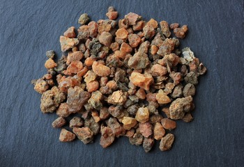Myrrh incense tears (myrrhae gummi from kenia) in tears on a grey slate stone background