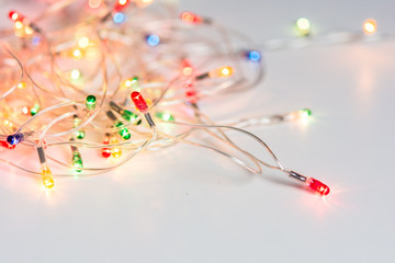 Closeup of Christmas lights on white table