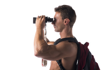 Fototapeta na wymiar Shirtless muscular young man with binocular and backpack