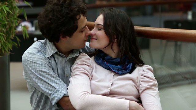 Love couple in shopping center kissing after shopping