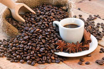 coffee cup and grains on wooden table