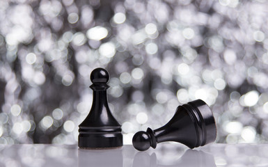 Black Pawns on festive bokeh background