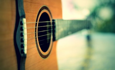 Fototapeta premium detail of acoustic guitar with shallow depth of field
