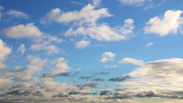 Low-flying clouds on a bright blue sky