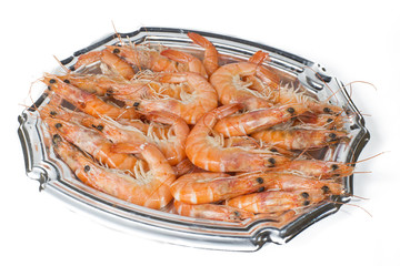 Tray of cooked prawns on white background