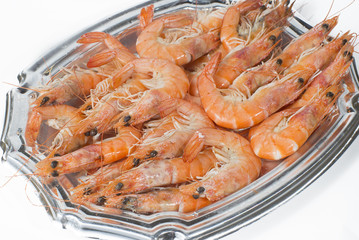 Tray of cooked prawns on white background
