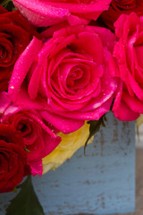 red and pink roses on table