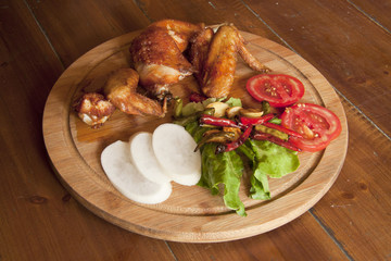 grilled chicken wings on a wooden plate