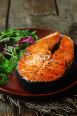 grilled salmon on a salad of arugula