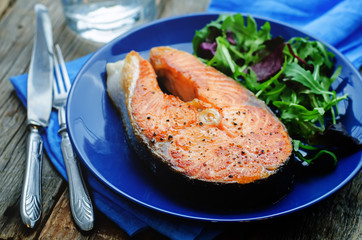 grilled salmon on a salad of arugula