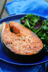 grilled salmon on a salad of arugula