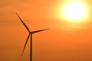 Fototapeta premium Wind turbines silhouette at sunset