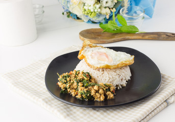 Dish of rice - egg and stir fried chiicken with basil