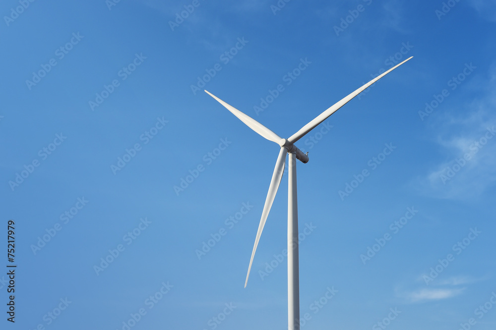 Wall mural wind turbine against cloudy blue sky background