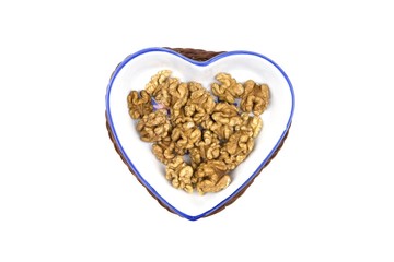 hazelnut kernel on a porcelain dish in the shape of a heart
