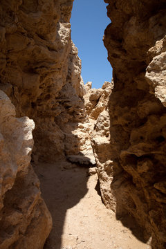 Crevice in the rock, forming a tunnel. tinted