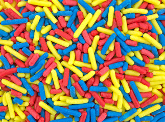 Fototapeta na wymiar Red blue and yellow candy sprinkles