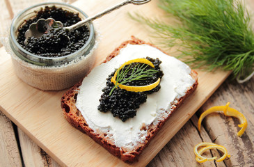 Black caviar and cream cheese on a dark bread