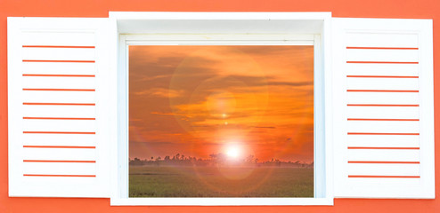home window on orange wall have sunset